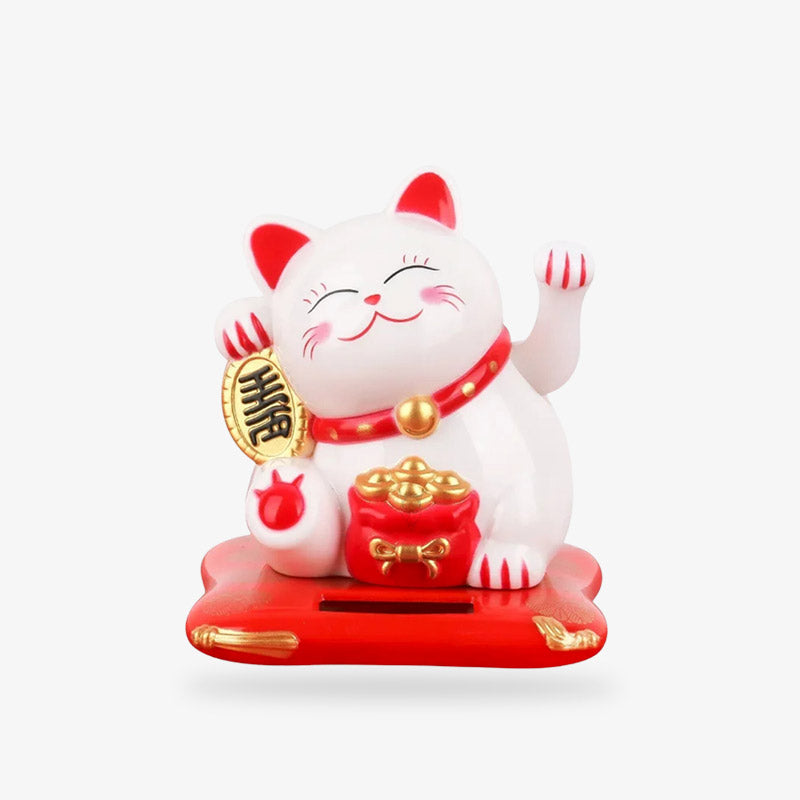 The Japanese Cat Maneki Neko is a Japanese lucky talisman. It is a small statuette of a white and red cat holding a koban coin in its paw. Its left paw is raised and moves to attract customers. This Neko Maneki cat symbolises singing, prosperity and good fortune.