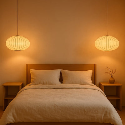 Bedroom with wooden headboard, beige bedding, and two japanese chandelier modern hanging lights casting a warm glow.