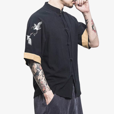 a man dressed with Japanese design t-shirt incorporating embroidered tsuru birds japanese cranes.