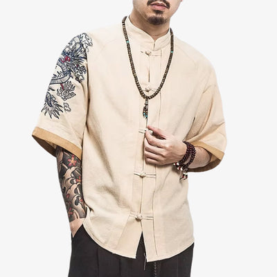 A man is dressed with a Japanese dragon t-shirt featuring a powerful dragon motif embroidered inspired by traditional Japanese mythology, ideal for bold streetwear looks.