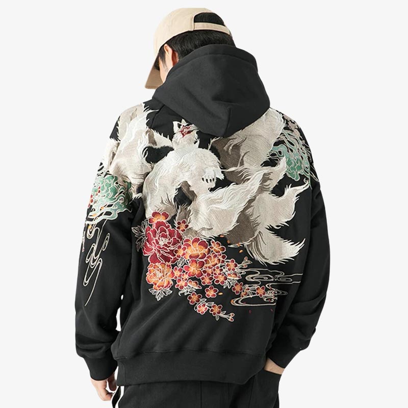 A man is dressed with Japanese embroidered hoodie featuring detailed and vibrant embroidery, made from comfortable and durable material, perfect for a stylish look