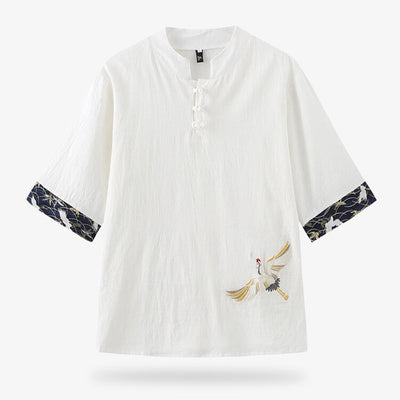 This Japanese embroidered shirt is made with a Tsuru crane motif on the fabric. The t-shirt has a button-down collar. The colour of the fabric is white and the material is cotton and linen.