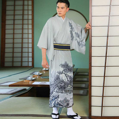 To take part in a tea ceremony, put on a Japanese formal kimono for men. The japanese man is standing in the tea house. He wears white tabi socks and geta sandals. The japanese kimono for men is tigh with an obi belt. Japanese pattern are embroided on the cotton material