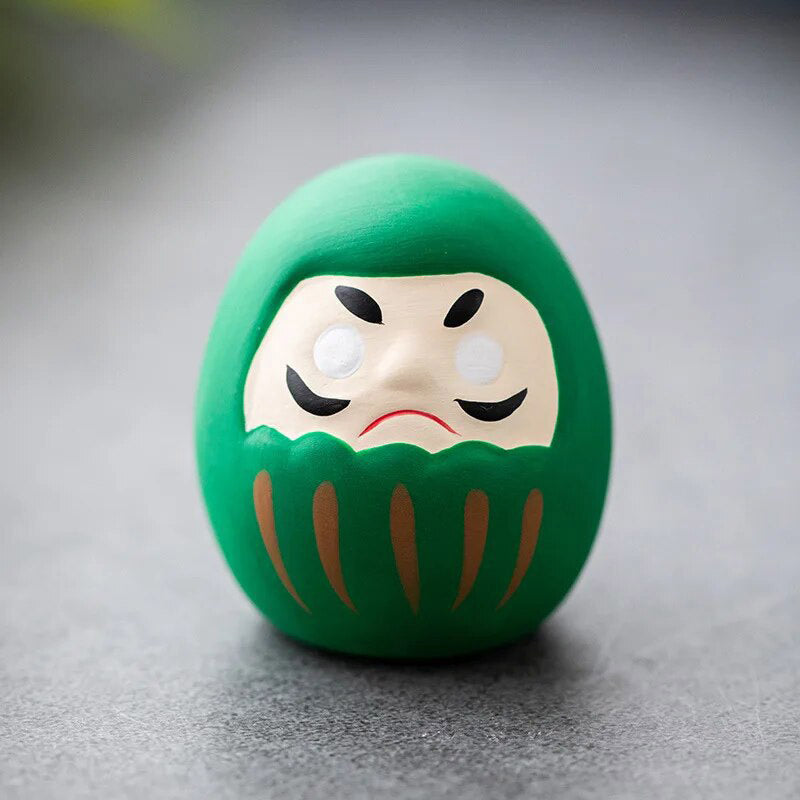 The Japanese green daruma doll is a decoration. Green in Japanese culture is associated with health. The Japanese daruma doll is a lucky charm.