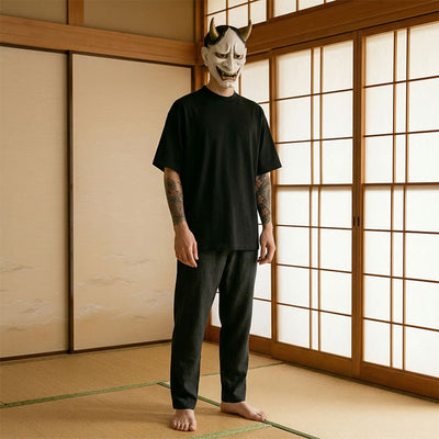 Person wearing a black mask with horns in a traditional Japanese room and japanese harajuku t-shirt
