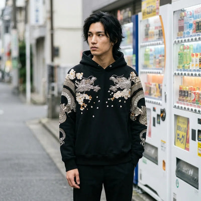 The Japanese hoodie for men worn beside a row of lit vending machines on a Tokyo street in the evening