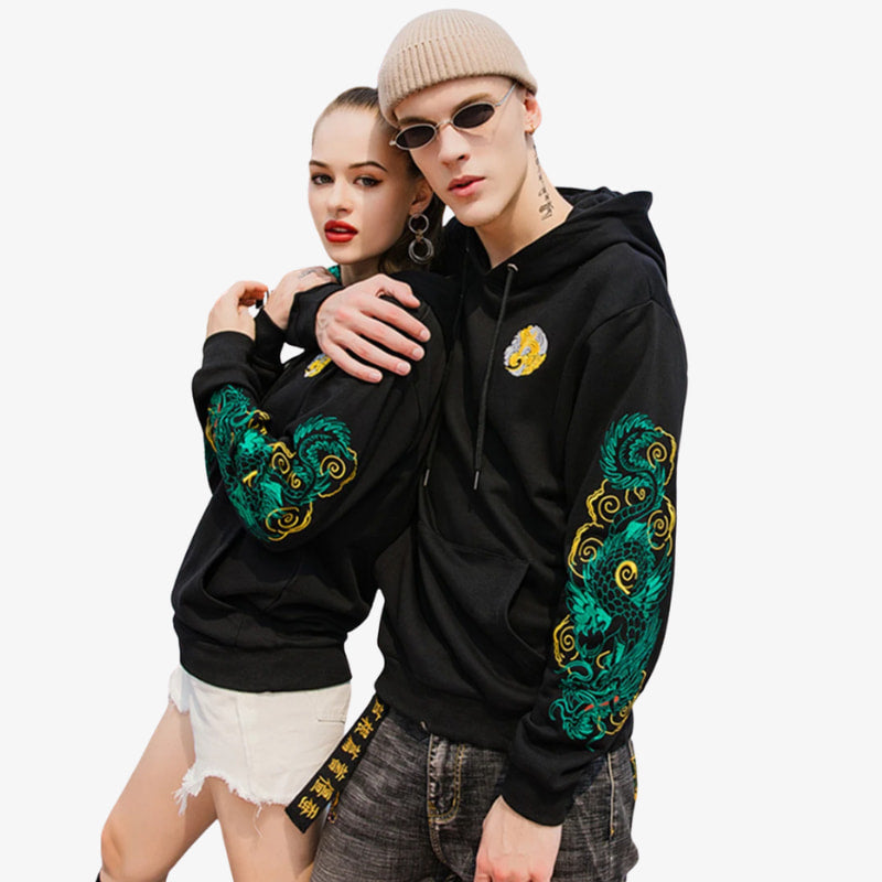 Two people wearing japanese hoodies black with green and gold designs on a white background