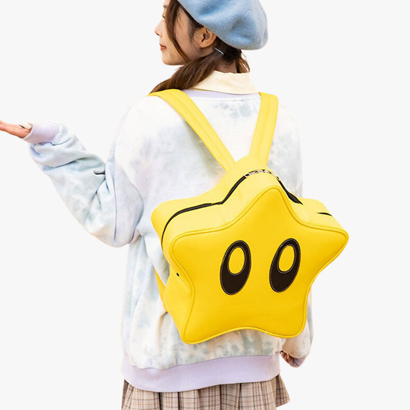 A woman wears a yellow japanese kawaii backpack on her back in the shape of a magic star.