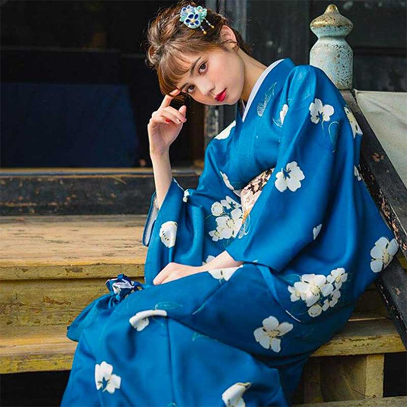 Japanese kimono traditional dress with printed flower designs. A woman stands gracefully, wearing this classic attire adorned with traditional floral motifs