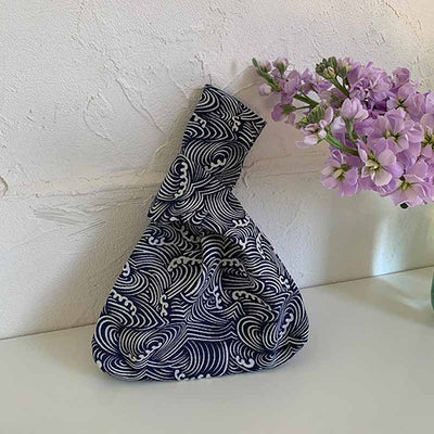 This Japanese pattern bag is printed with waves. It is a Japanese handbag with a bow. Delve into the history of the japanese knot bag origin in japan, a fashion staple that symbolizes Japanese ingenuity.