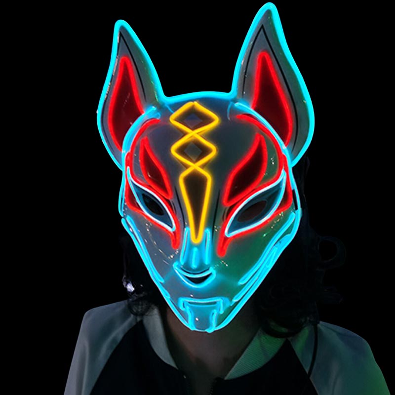 A girl wears japanese led face mask. The japanese mask is a kitsune fox with white, yellow and red colors