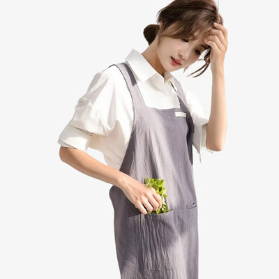 Japanese linen apron dress designed with breathable natural fibers and crossed back straps, balancing comfort and traditional style.