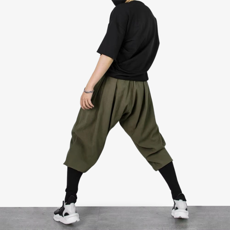 A man is dressed with green Japanese loose pants with wide legs and breathable fabric, inspired by traditional Japanese pants, the shinobi ninja outfit and the japanese streetwear style