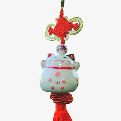 This japanese lucky cat charms is a Maneki Neko cat to hang from the rear-view mirror. The cat is white and made of ceramic. It hangs from a red thread.