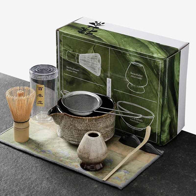 Japanese matcha tea set corresponding to a chasen whisk, chawan bowl, chashaku spatula, and ceramic whisk holder.