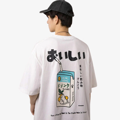 A man is dressed with a white Japanese oversize t shirt printed with Kawaii drawing, kanji, and Japanese bottle milk