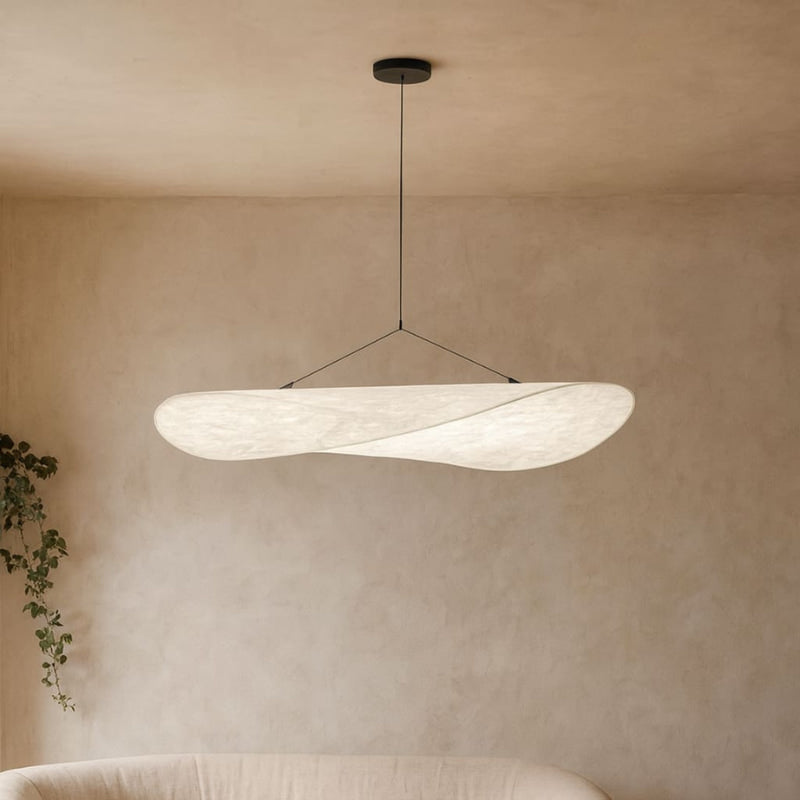 Modern Japanese Paper Lamp Ceiling pendant hanging in a room with a neutral wall and plant.
