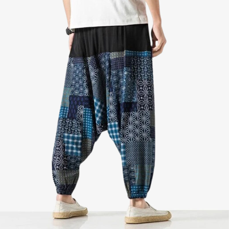 A man from the back is wearing Japanese prints pants with geometric patterns such as Wagara. Japanese pants with dark blue color and wide legs cut