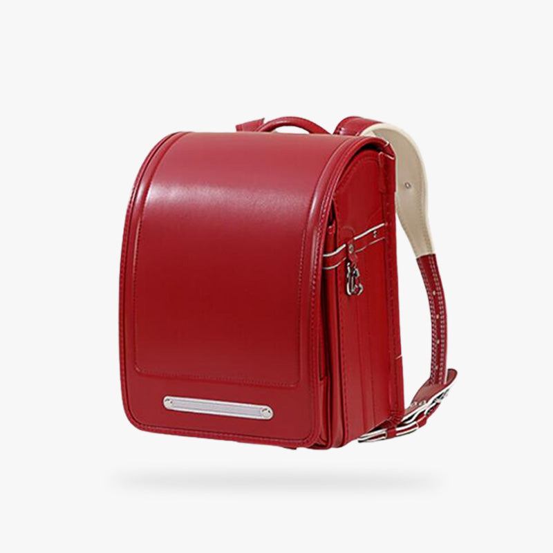 This japanese randoseru backpack is red with shoulder straps. It's a traditional Japanese leather bag