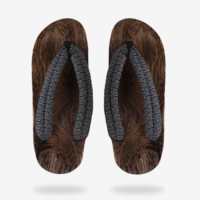 Japanese sandals made of polished wood, traditional design motif with fabric straps. 