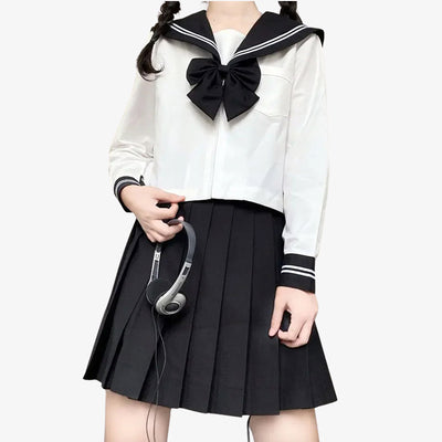 a women is standing and dressed with a japanese schoolgirl sailor uniform, She wears a black japanese skirt, a long sleeve white japanese shirt and a black ribbon with white stripes