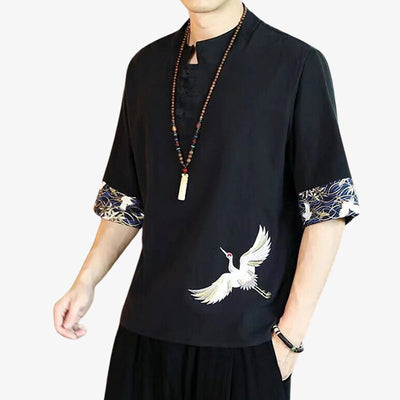 The best Japanese shirt website. A man is wearing a traditional black t-shirt embroidered with a Japanese bird motif (tsuru).