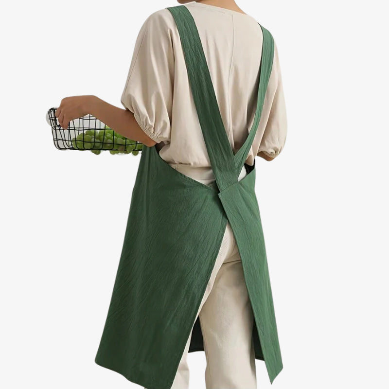 Japanese style cross back apron in natural fabrics combining functionality with traditional design, featuring a crossed strap system for secure wear.