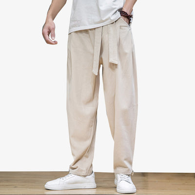 A man wears Japanese-style loose pants with an Obi belt around his waist.