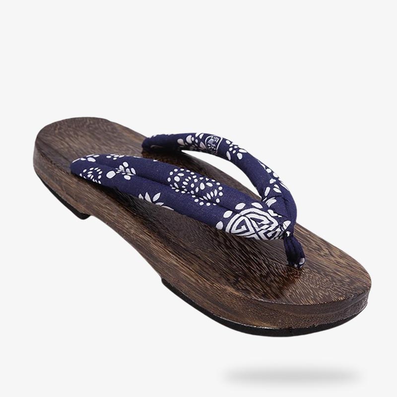 These traditional Japanese sandals are wooden zori shoes. The sole is flat and carved in light wood.