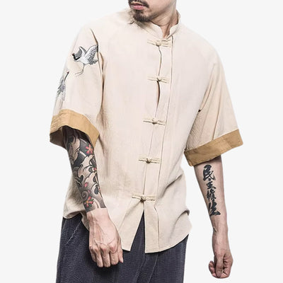 a man is dressed with Japanese traditional t-shirt combining symbolic graphics tsuru pattern with a modern casual look, perfect for expressing cultural roots. The cream japanese shirt is made with cotton and linen, and buttons to close the short sleeves shirt