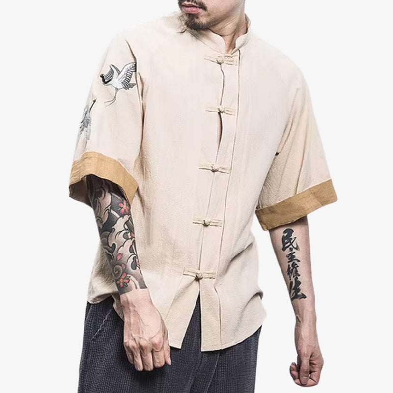 a man is dressed with Japanese traditional t-shirt combining symbolic graphics tsuru pattern with a modern casual look, perfect for expressing cultural roots. The cream japanese shirt is made with cotton and linen, and buttons to close the short sleeves shirt