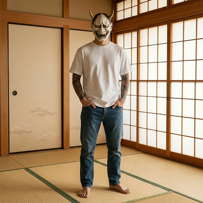 Person wearing a white japanese white t-shirt and blue jeans standing in a traditional Japanese room with shoji screens.