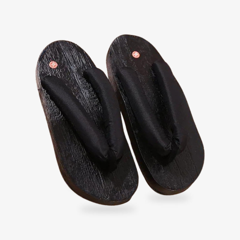 Durable Japanese wooden flip flops, combining traditional aesthetics with practicality. Black japanese geta sandals with black straps