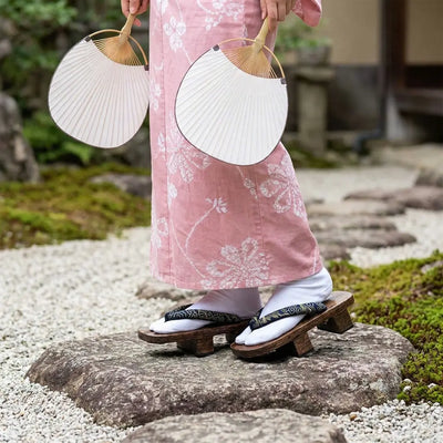 Japanese Wooden Geta Sandals worn with a pink kimono in a Japanese garden