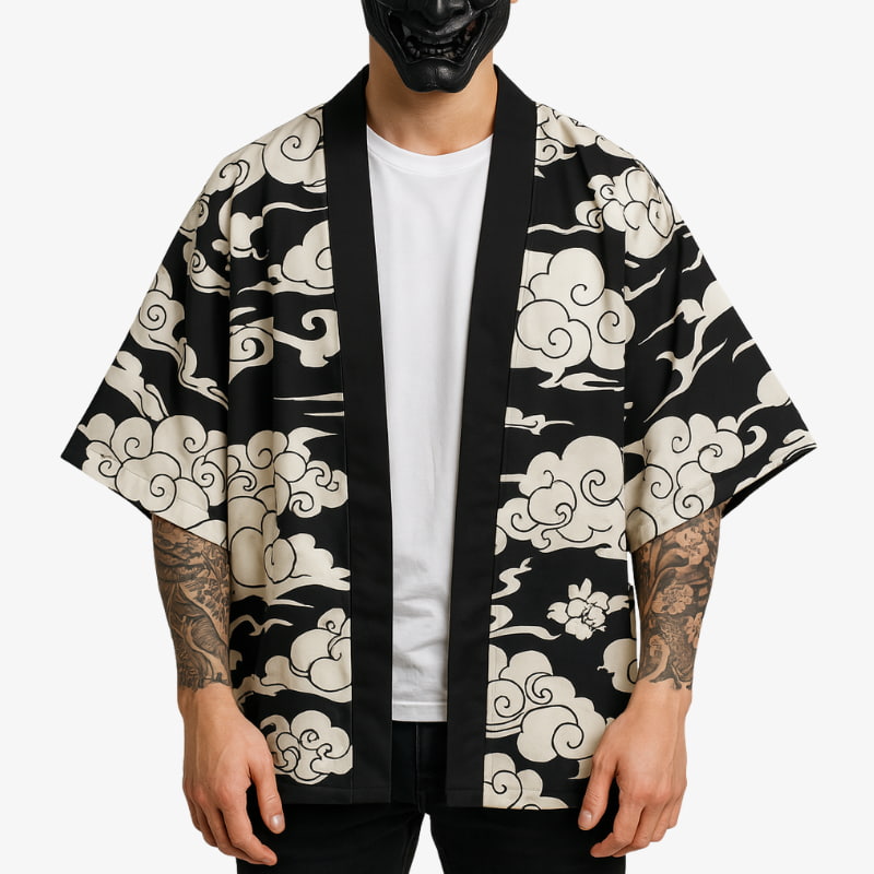 Person wearing a black kimono cloud with Tattoo on his arms on a white background