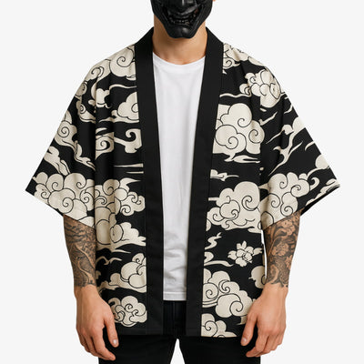 Person wearing a black kimono cloud with Tattoo on his arms on a white background