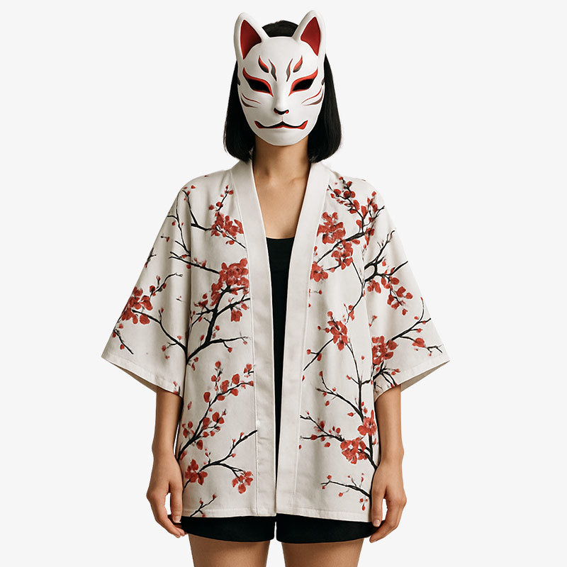 a women is dressed with a kimono jacket for ladies. She has a traditional kitsune mask on her face. The kimono jacket is made with cotton
