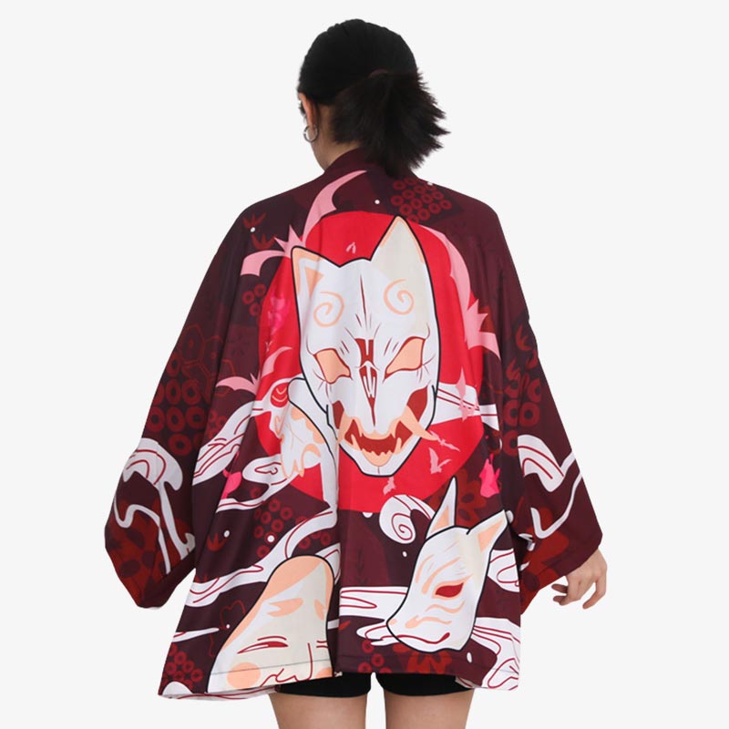 The kimono jacket pattern features a Japanese Kitsune mask print, blending traditional design with modern fashion in a stylish kimono jacket