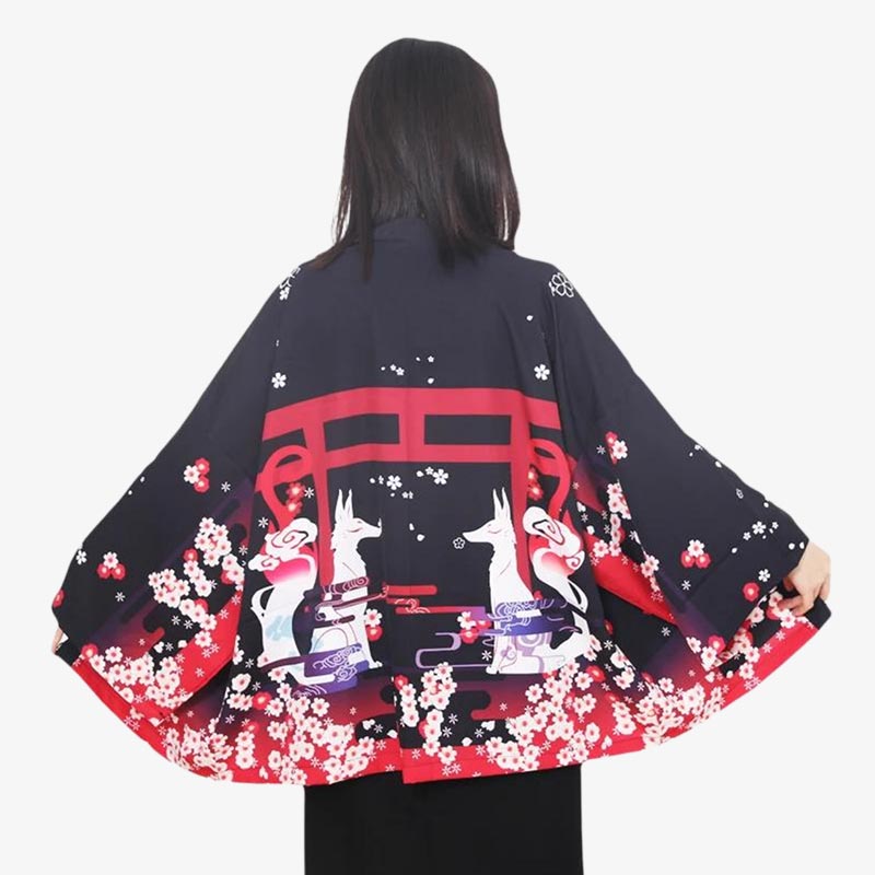 Embrace the mystique of Japanese folklore with the kitsune kimono, featuring beautiful fox spirit designs. The japanese fox are protecting the red torri door. The women Japanese kimono is blacck