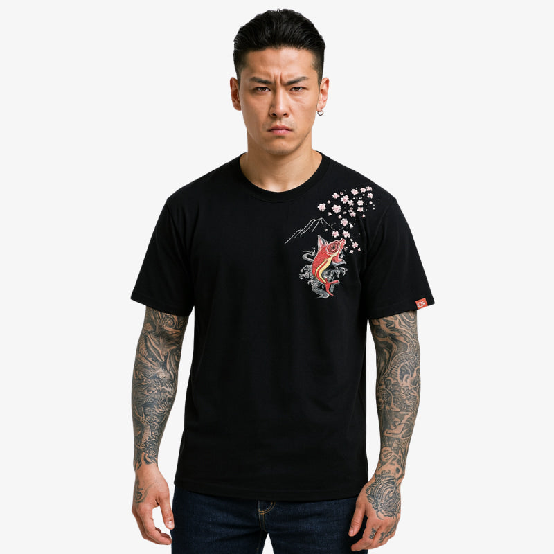 Man wearing a black koi fish shirt with a graphic design on a white background