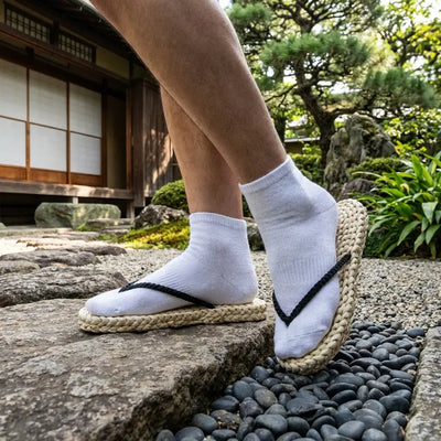 Luffy Sandals worn with white tabi socks in Japanese garden setting