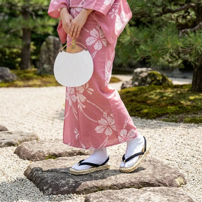 Luffy Sandals worn with a pink kimono in a Japanese garden