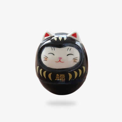 Maneki neko black cat made of ceramic material in the shape of a cute cat's head.