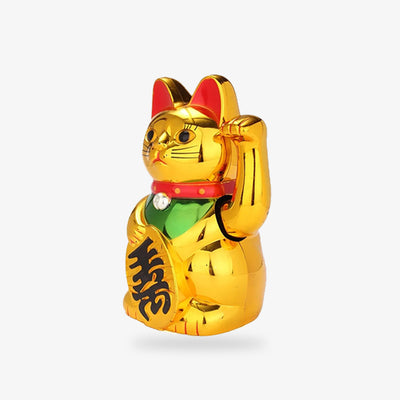 The Japanese lucky maneki neko gold cat has its left paw raised. Gold color and metal fabric