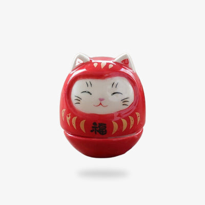 This Japanese decorative object is a red kawaii maneki neko cat. It's a Japanese good luck charm made of ceramic.