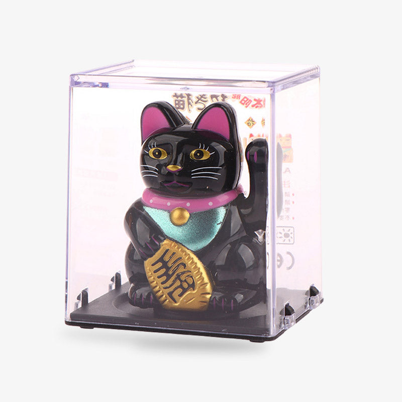 A Maneki neko solar powered cat that moves its arm using solar energy. The lucky cat is made of PU. The black colour of the Japanese cat also scares away evil spirits. The Japanese maneki is a decorative object that brings good luck and wealth.