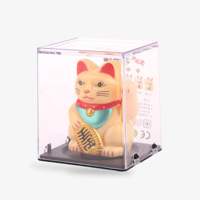 This maneki neko traditional Japanese cat is gold in colour. It holds a Koban coin in its hand and raises its left paw to attract luck, money and fortune.