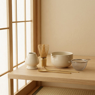 Japanese matcha Tea-making utensils on a wooden table with a shoji window