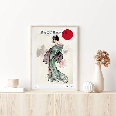 This modern geisha painting is a reproduction by Hokusai. This Japanese decorative object is positioned on a wooden cabinet.