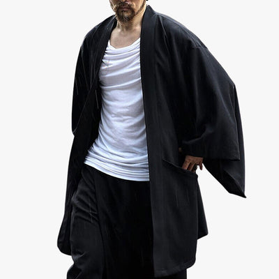 A Japanese man wears a modern kimono for men with a white t-shirt and cargo trousers